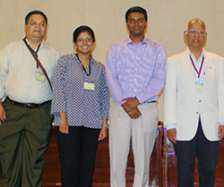 ravindran with a colleague and graduate students at a symposium